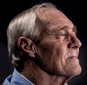 Old man wearing a hearing aid
