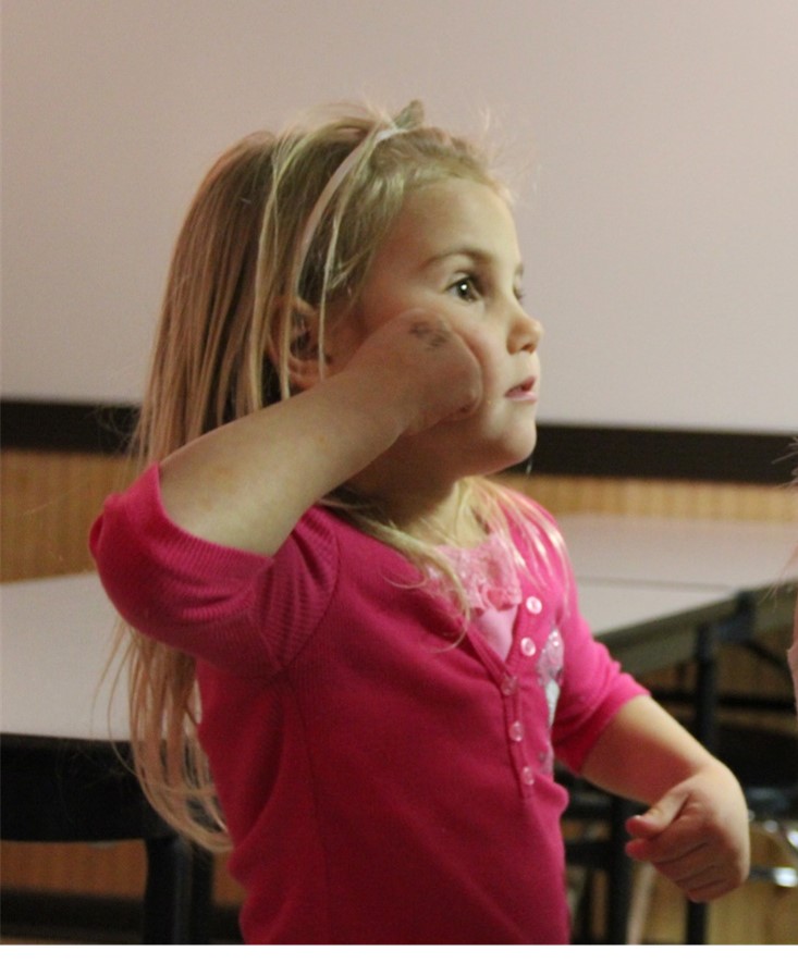 Little girl learning sign language