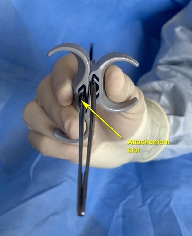 Adjustable ergonomic attachment for surgical forceps with preferred finger position for increased stability comfort during surgery