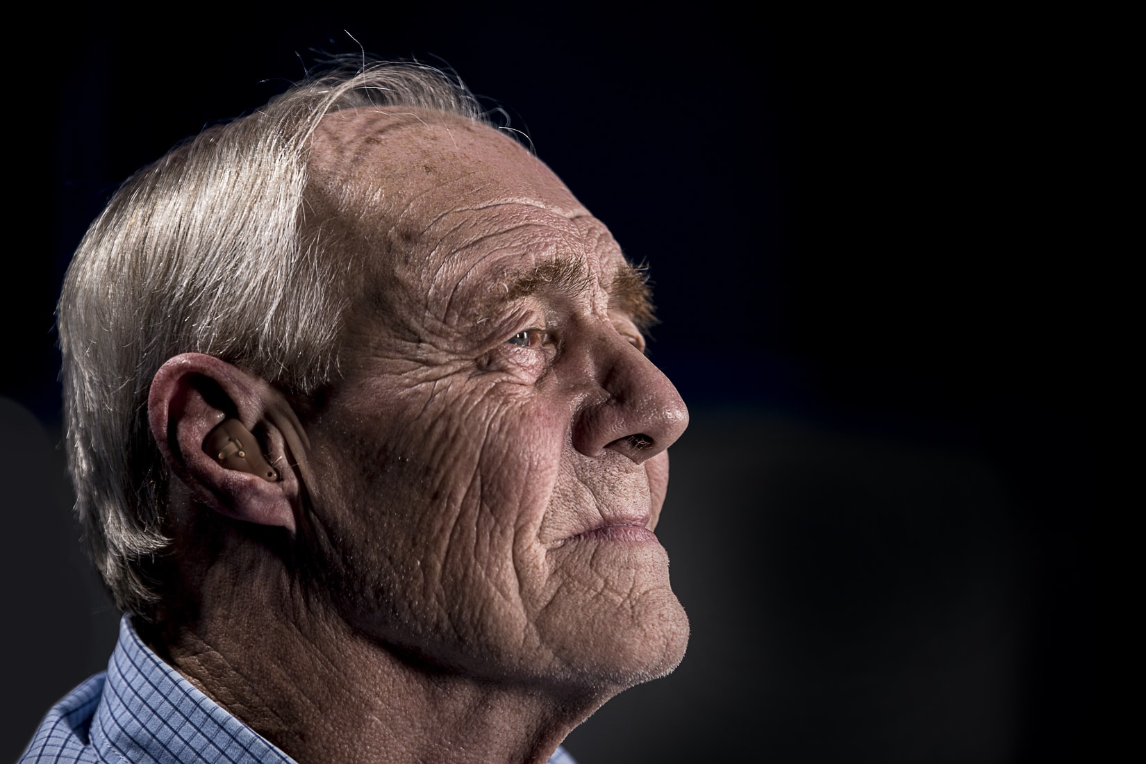 Older man with hearing aid