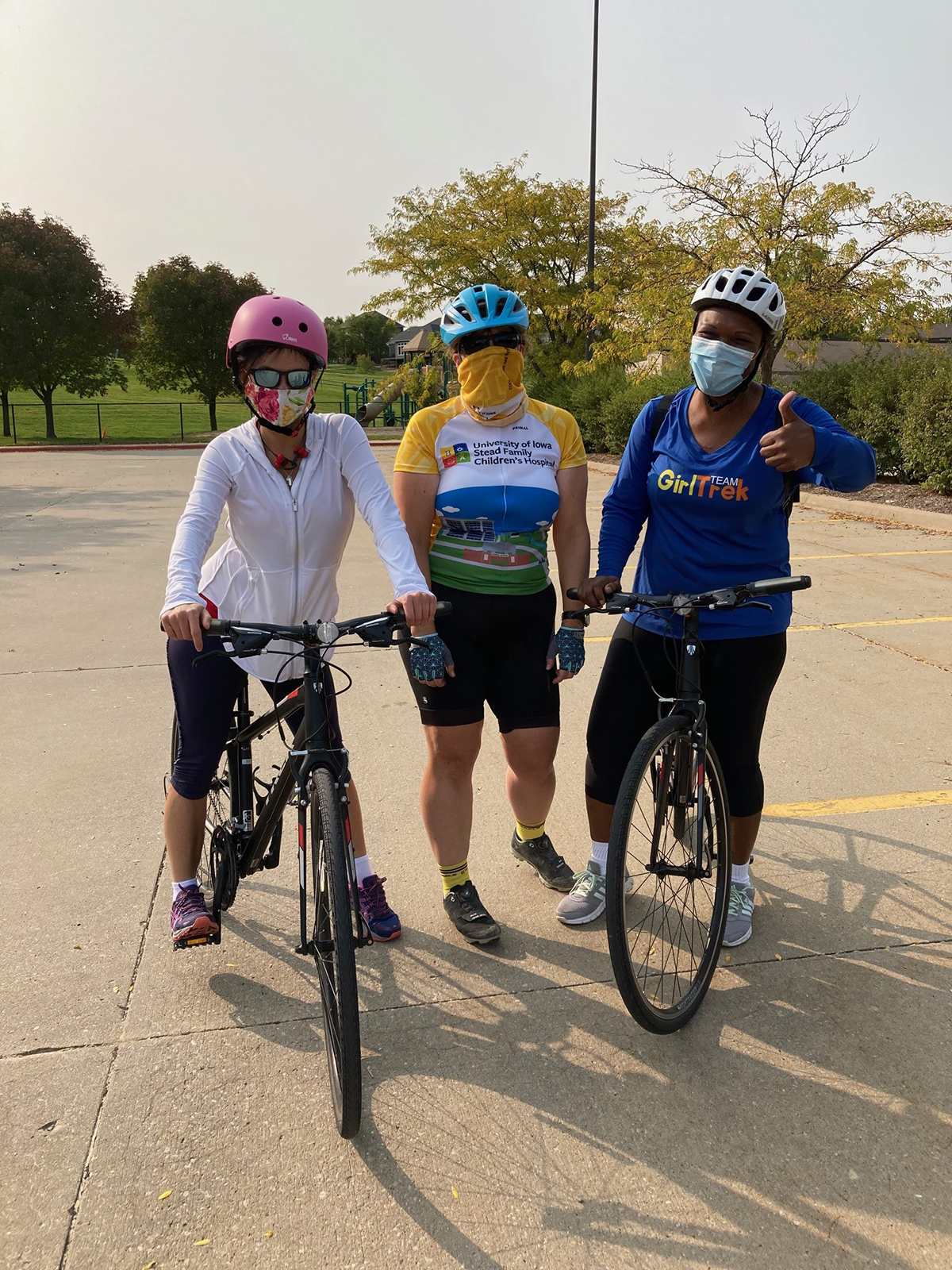 Three fellows biking safely wearing masks during the pandemic