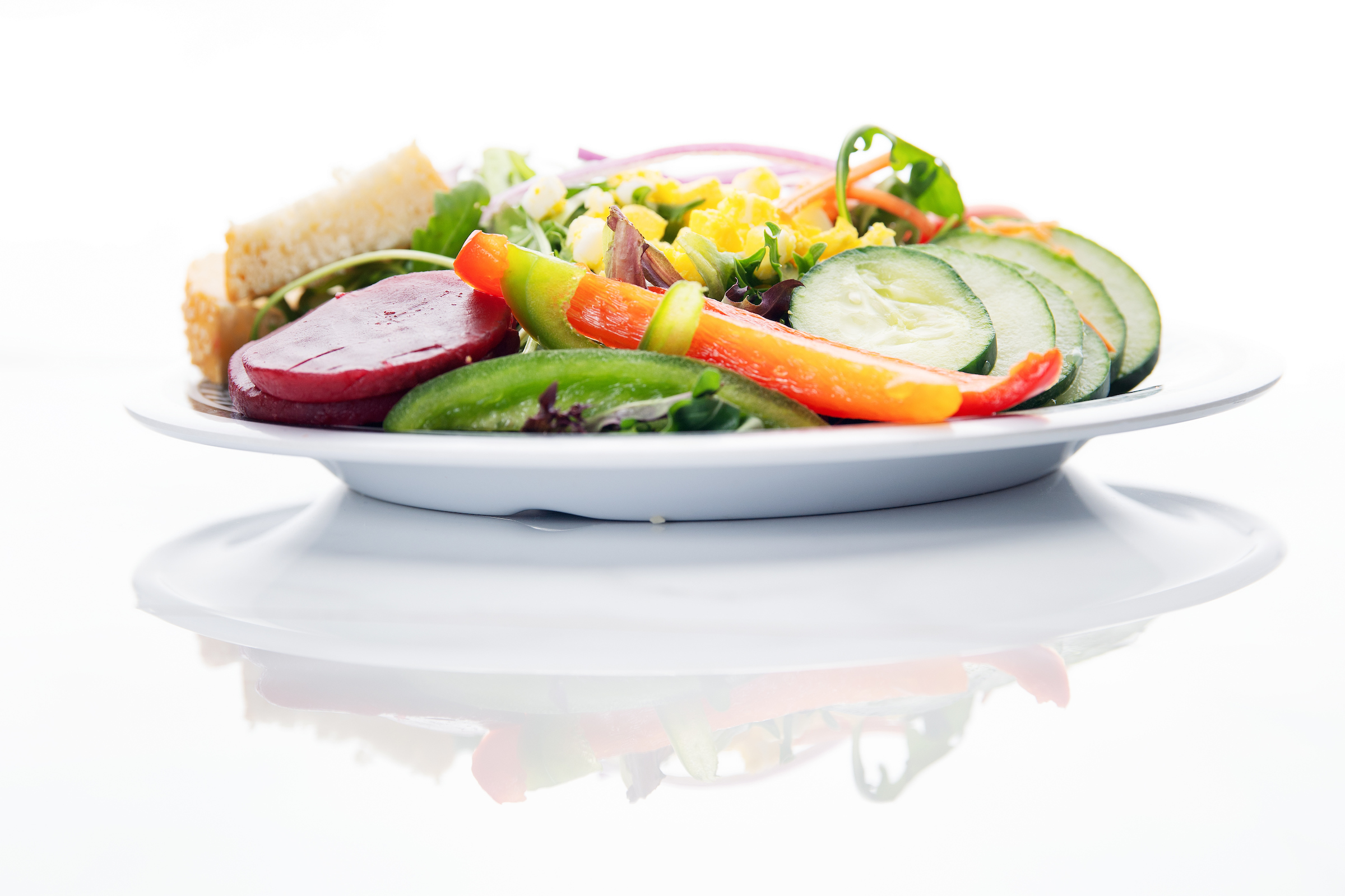 A plate of vegetable salad on a white background