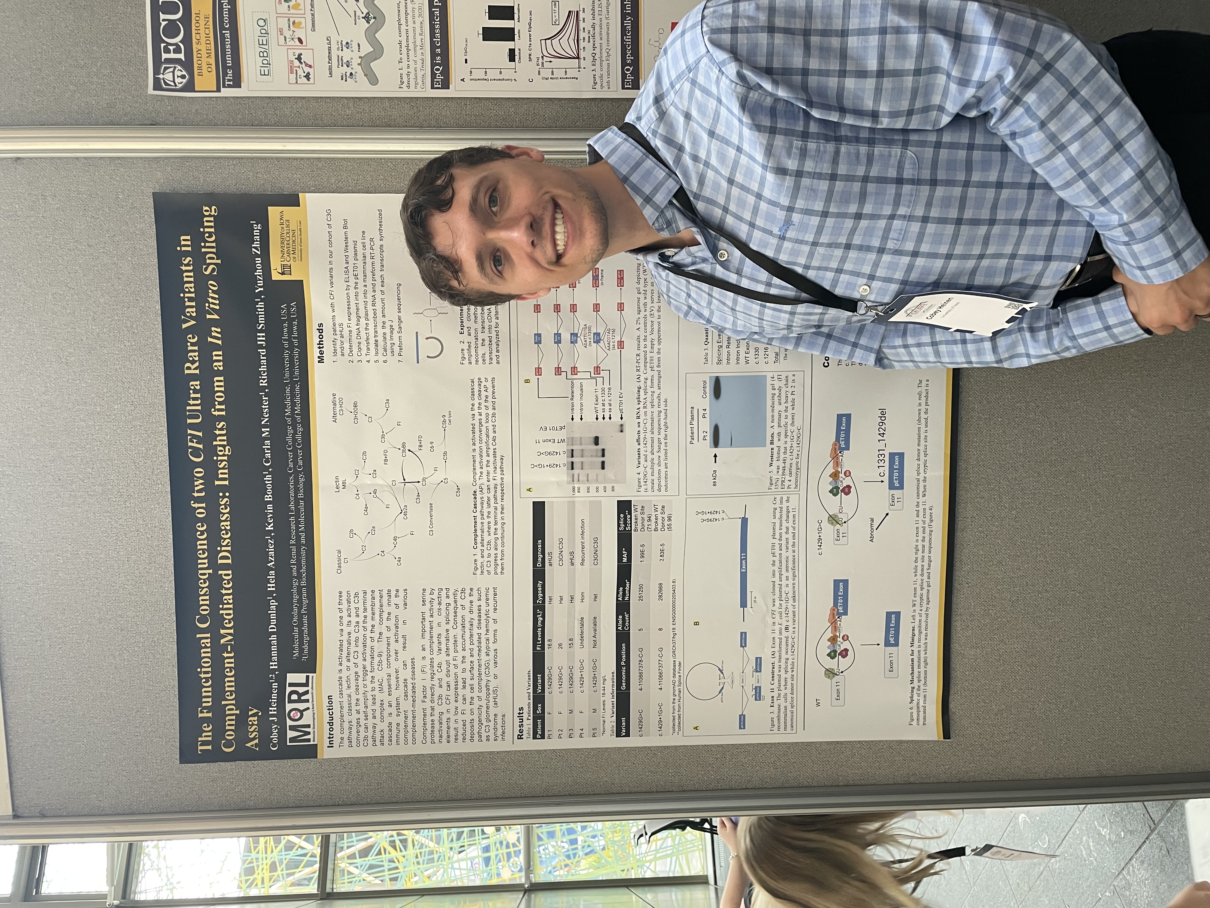 Cobey stands in front of his research poster, titled, 