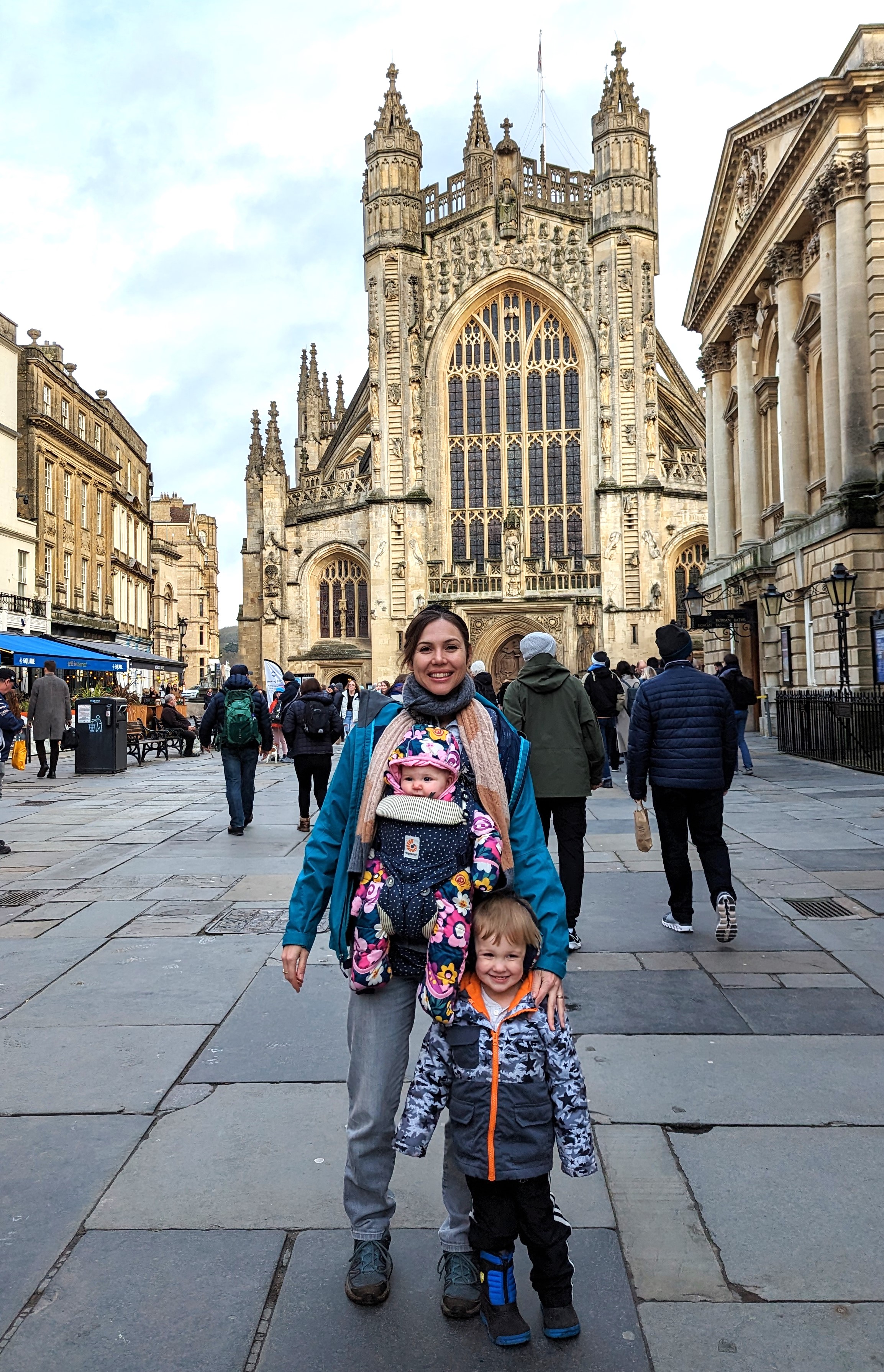 Jess De Haan with her two young children in front of a cathedral in Bath, England