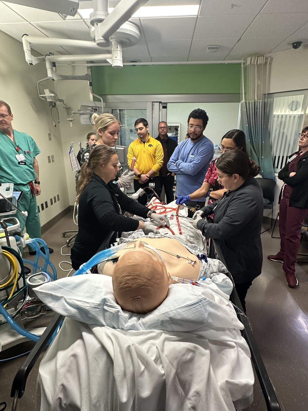 Medical learners practice ECMO skills on a simulation patient model.
