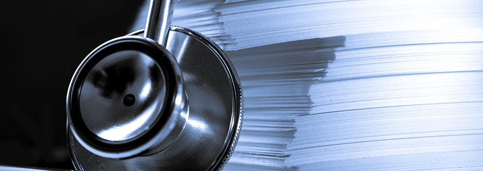 A photo of stethoscope next to a stack of papers stethoscope and papers