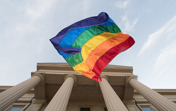 pride banner in front of campus building