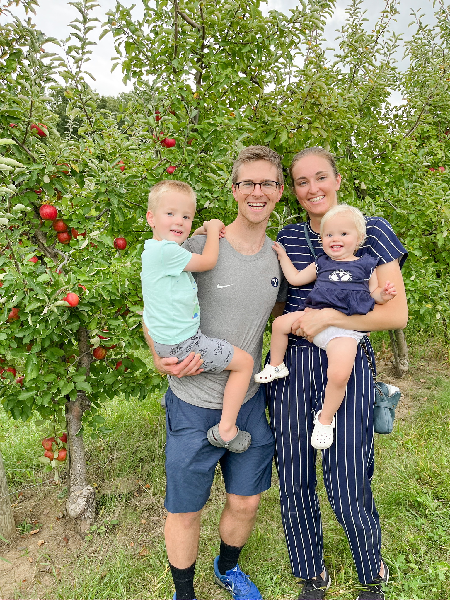 Tyler Wood with his wife Lizzie and two kids at an apple orchard.