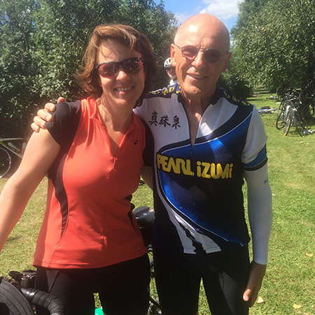 two cyclists standing by bike