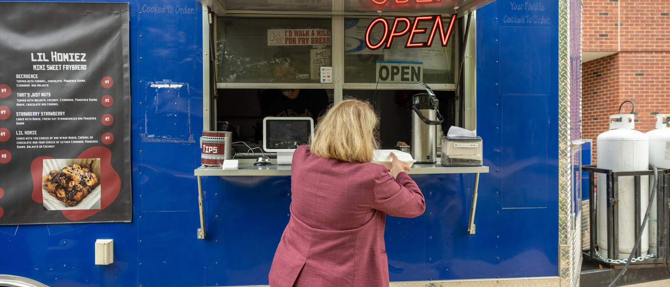 Dr. Denise Jamieson ordering from a food truck at Science Thursday