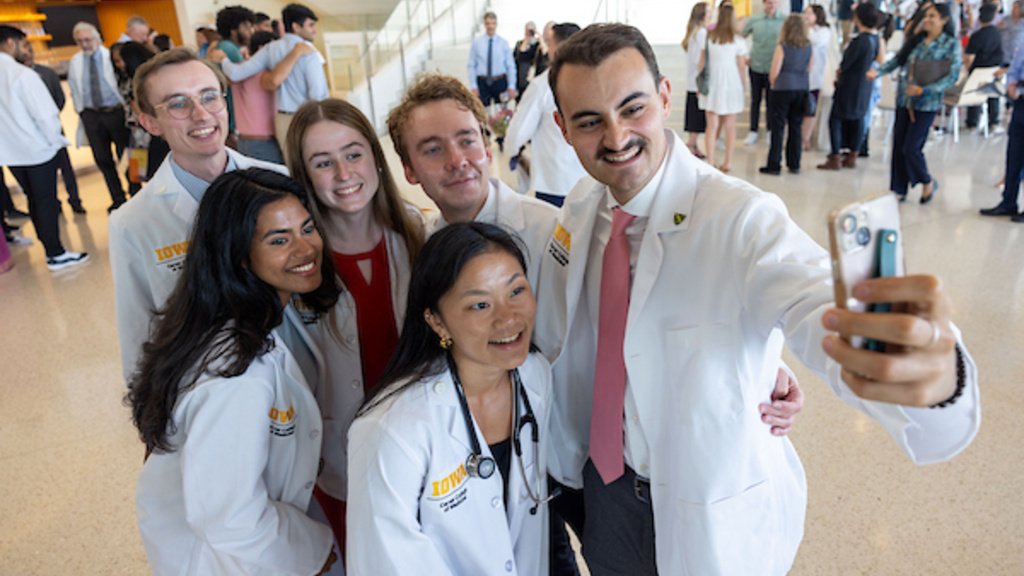 A group of medical students take a selfie after the White Coat Ceremony