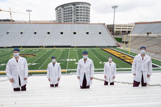 Our graduating 2021 Graduating Chiefs at Kinnick Stadium with the hospital behind them.